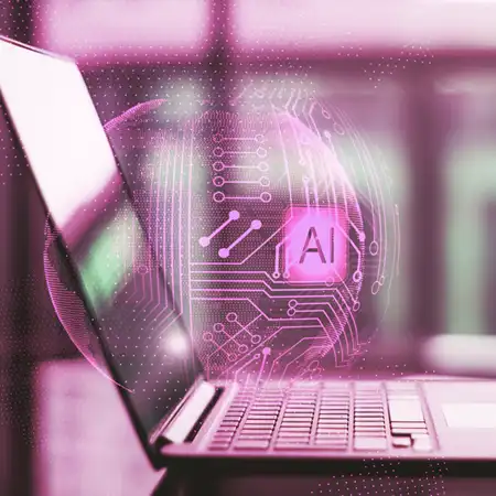 un computer portatile e in over una sfera wire frame con la scritta AI