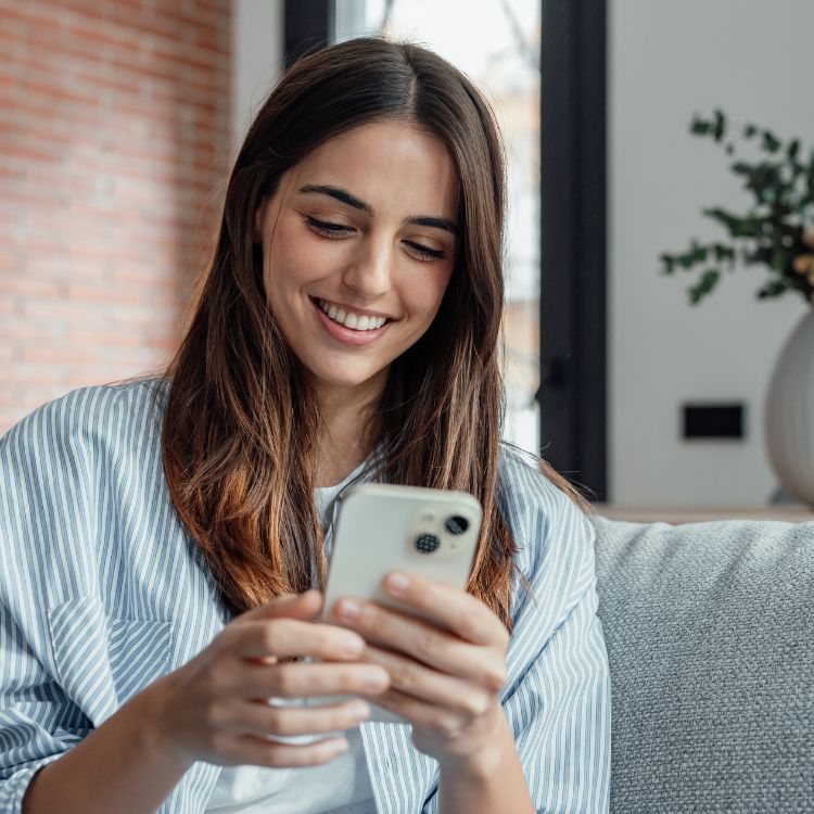 Girl smiles while watching an advertising campaign on her phone