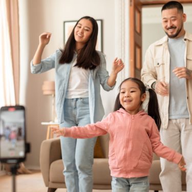 young family dance with kid