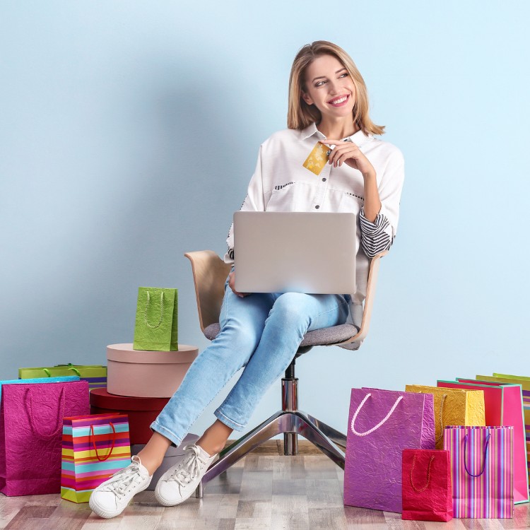 Blonde girl with computer wants to make an online purchase