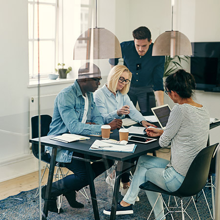 Persone al tavolo di un ufficio discutono strategia di marketing