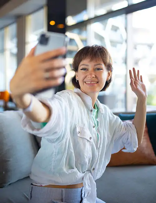 A creator takes a photo with her cell phone