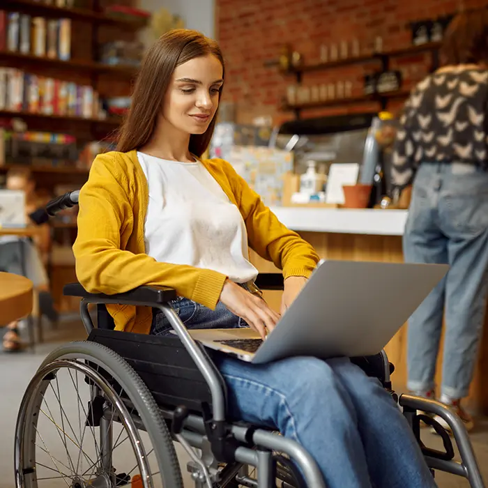 A person with a disability uses a computer to view an accessible website