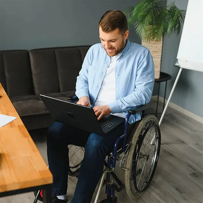 A person with a disability uses a computer to view an accessible website